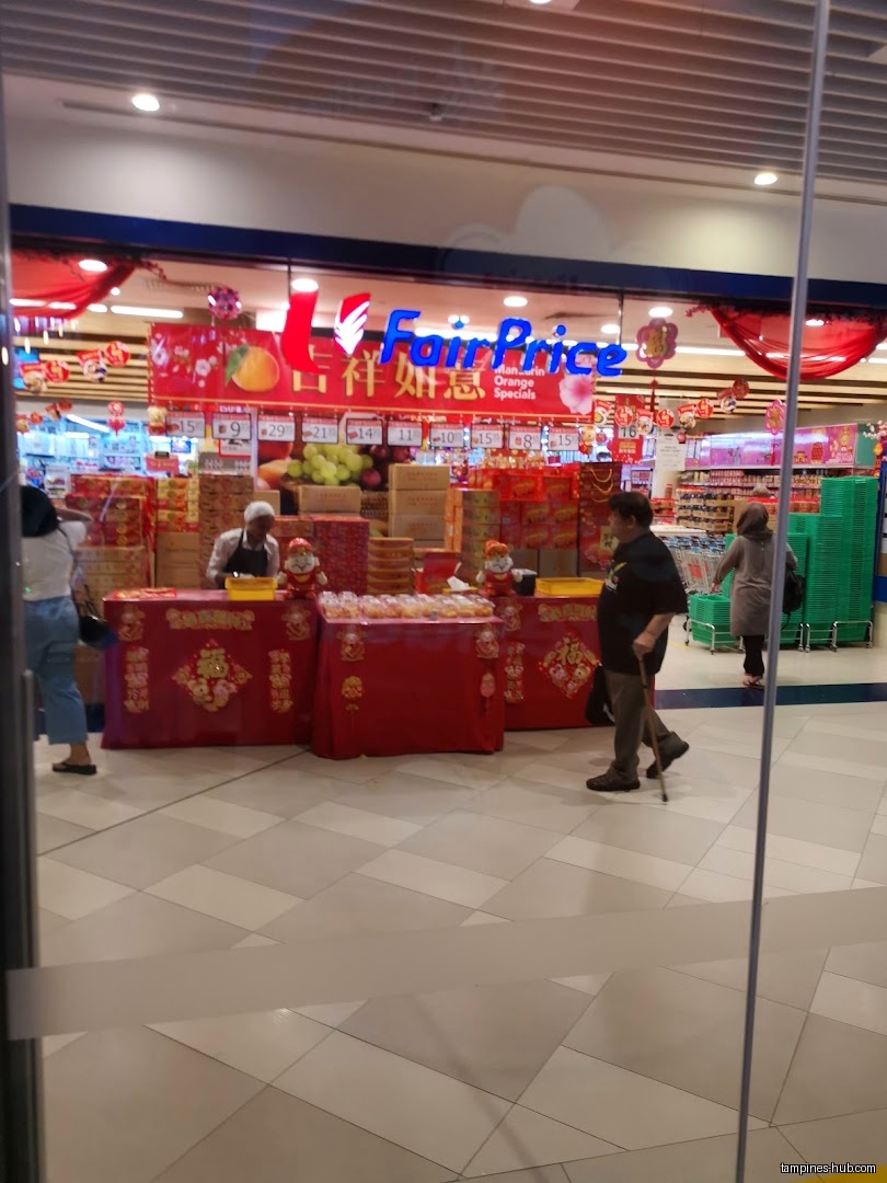 Festive Plaza's FairPrice entrance decorated for Chinese New Year with product displays.
