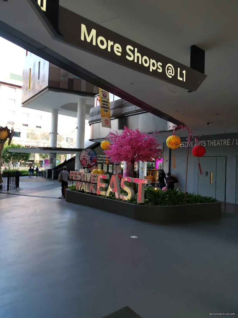 Festive Plaza entrance with 'Festive Walk East' sign and decorations.