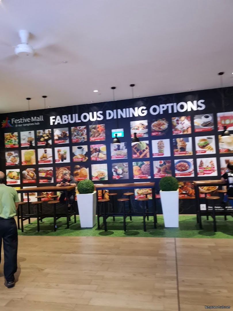 Festive Plaza's dining area features a wall menu and high-top seating.