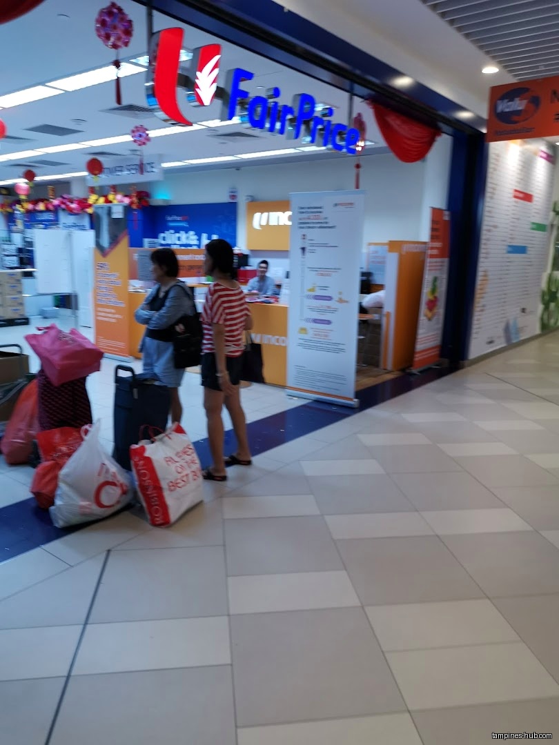 The image shows the entrance of a FairPrice supermarket in Festive Plaza.