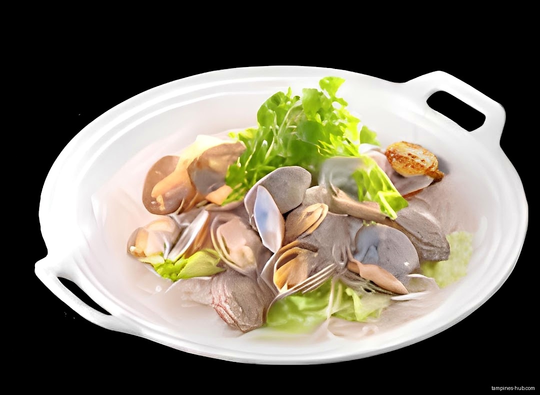 A white bowl holds clams, greens, and a fried scallop on black.