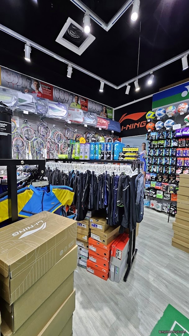 The image shows an interior view of the Flymax shop with sports equipment.
