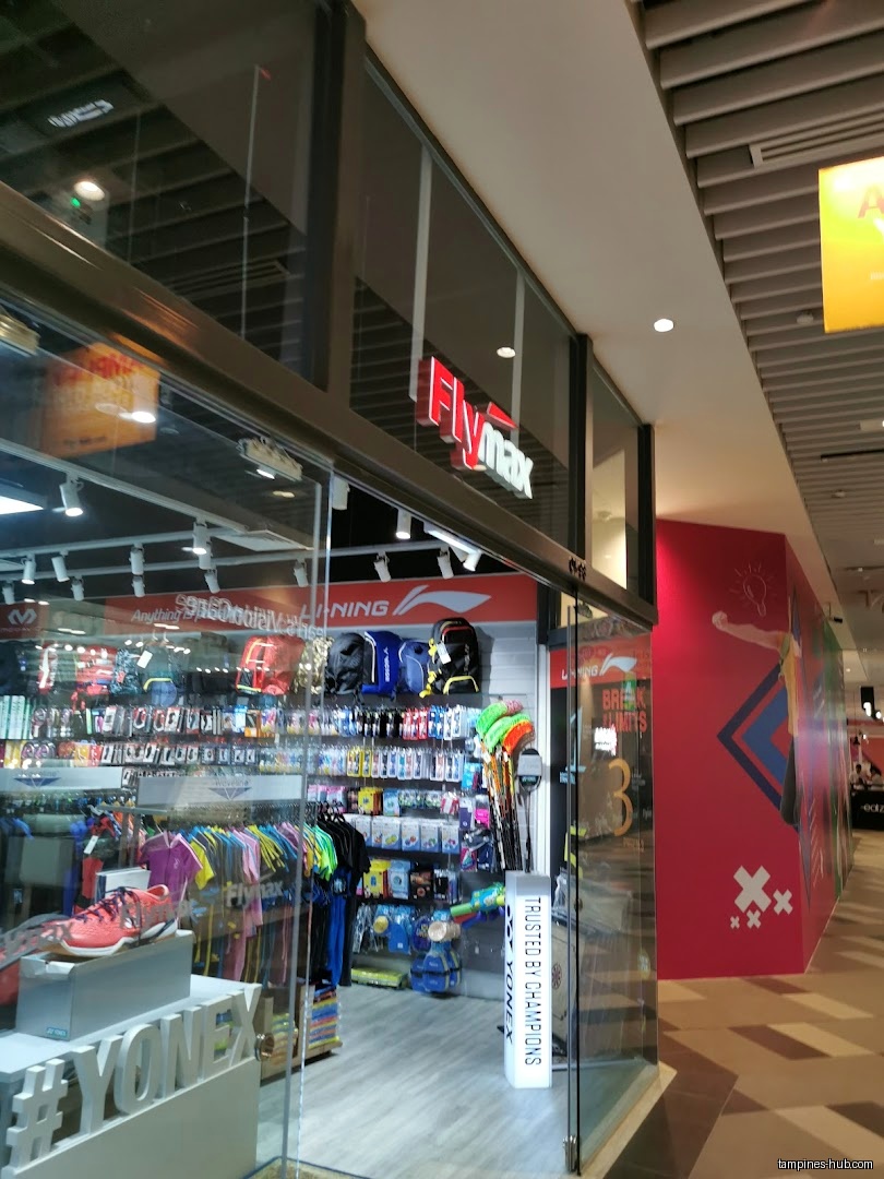 Flymax shop front with sporting goods and apparel visible through glass doors.