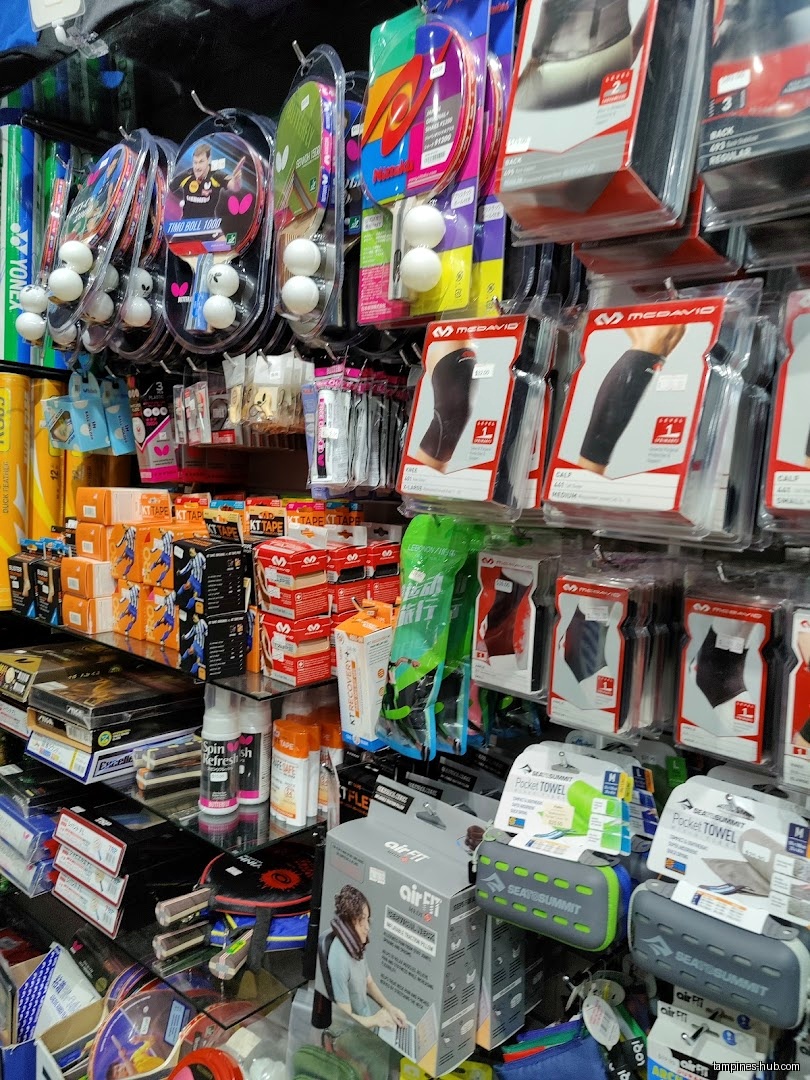 The image shows shelves stocked with sporting goods inside the Flymax shop.