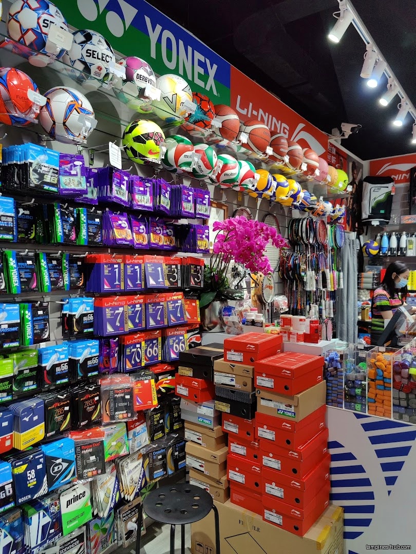 Flymax shop interior showing sports equipment, including balls, rackets, and shoe boxes.