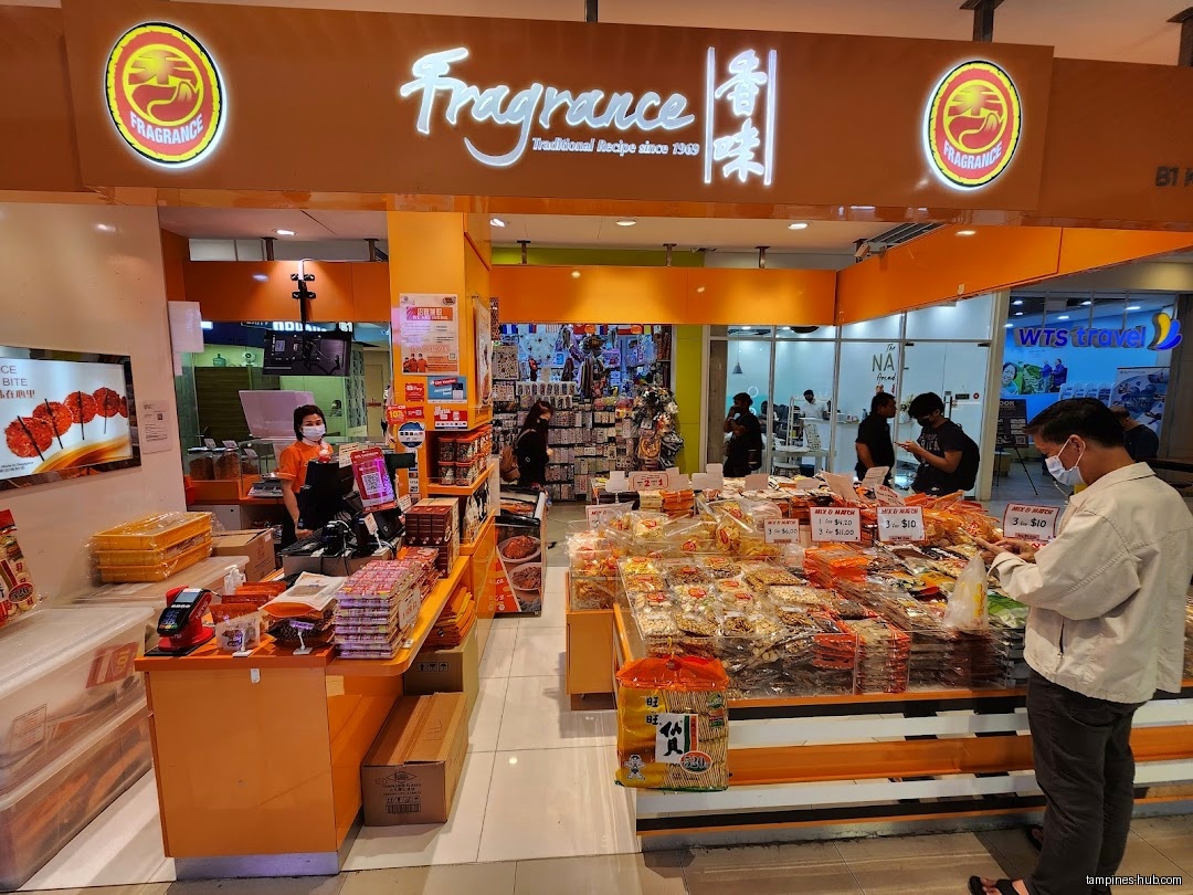 The Fragrance shop front displays snacks and has customers browsing inside.