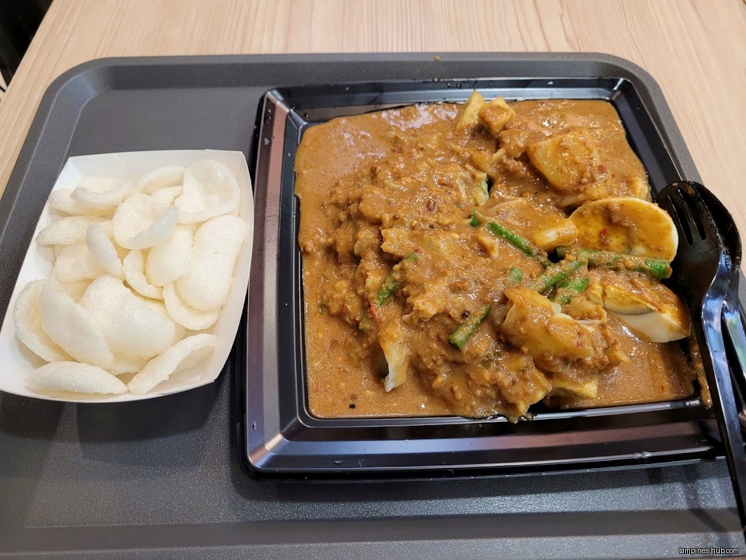 A plate of Gado-Gado with crackers on a tray.