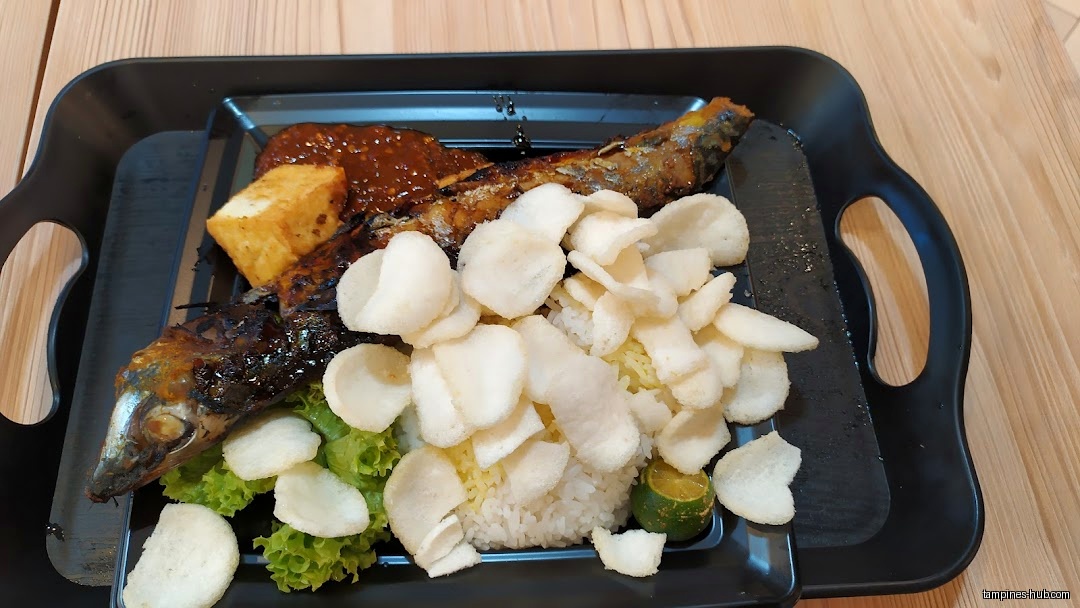 A plate of grilled fish, tofu, rice, crackers, and sauce is shown.