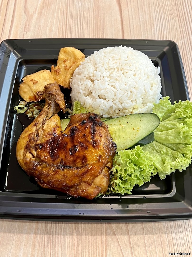 A plate of chicken rice with tofu and lettuce is displayed.