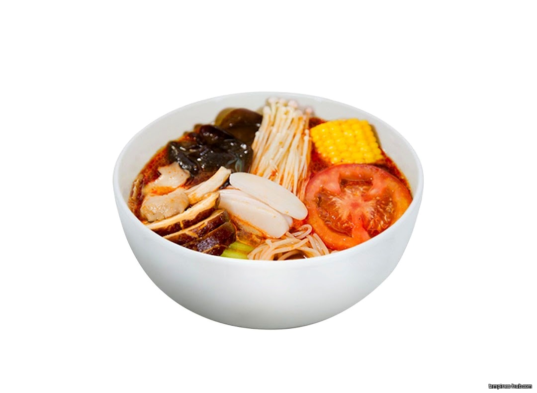 A white bowl filled with Ma La Tang ingredients like vegetables and mushrooms.