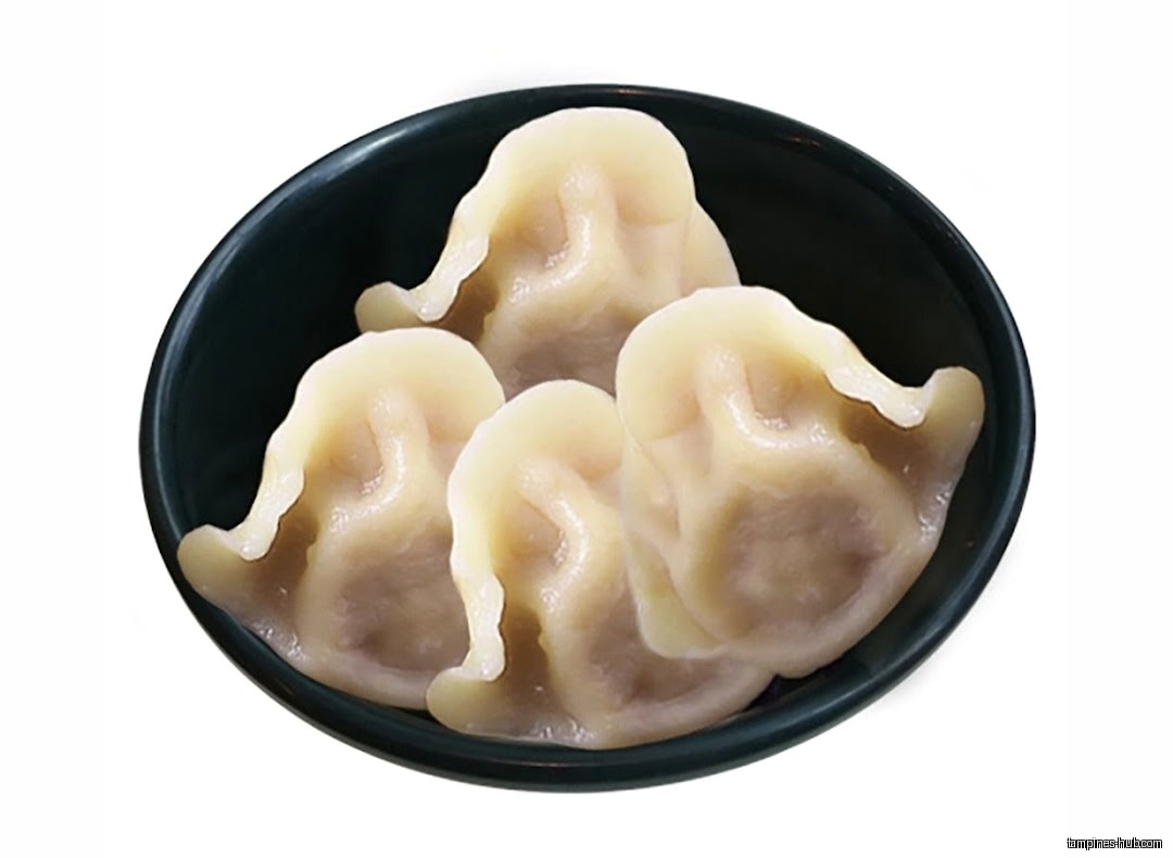 A bowl contains four steamed dumplings, likely offered at the shop.