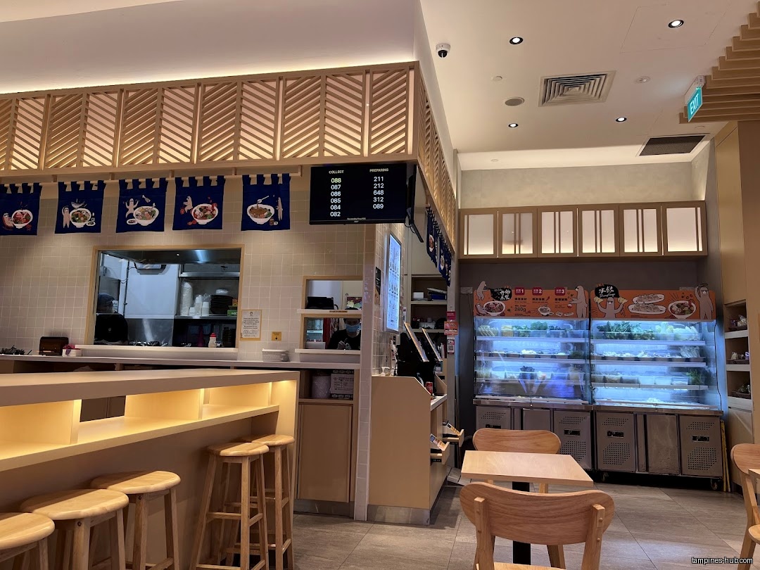 Interior view of Gong Yuan Ma La Tang with seating and food display.