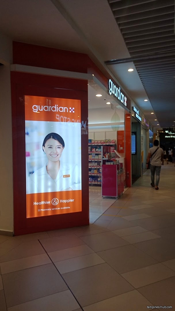 Guardian Health & Beauty shop front with a large advertisement panel.