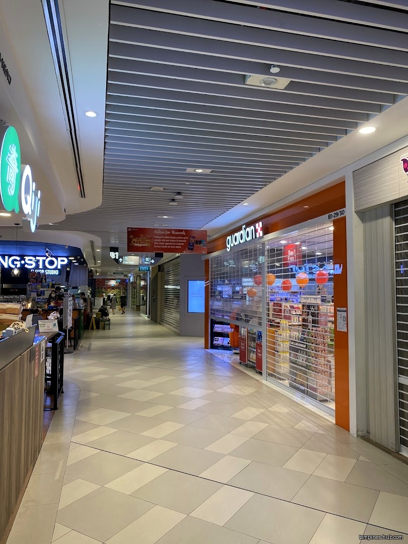 Guardian Health & Beauty shopfront with closed shutters in a mall hallway.