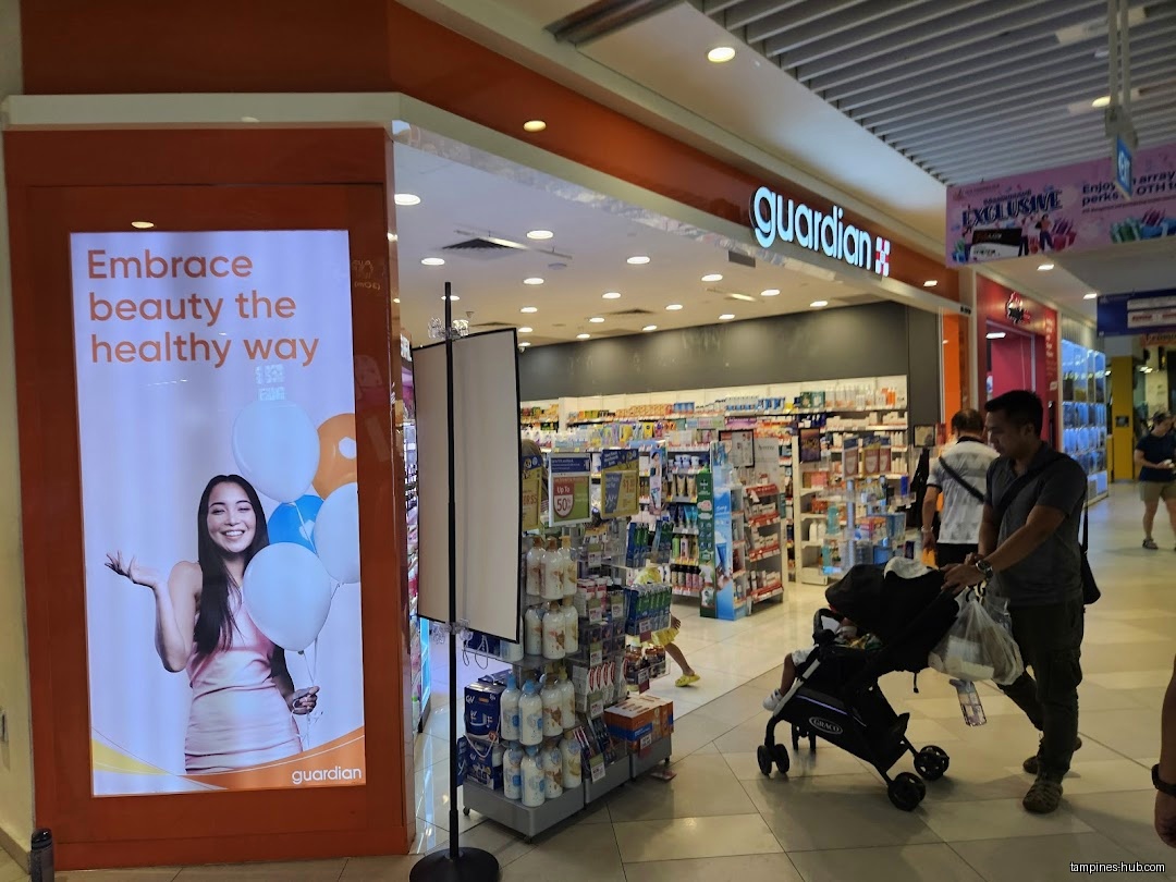 The Guardian Health & Beauty shop front with a promotional poster.