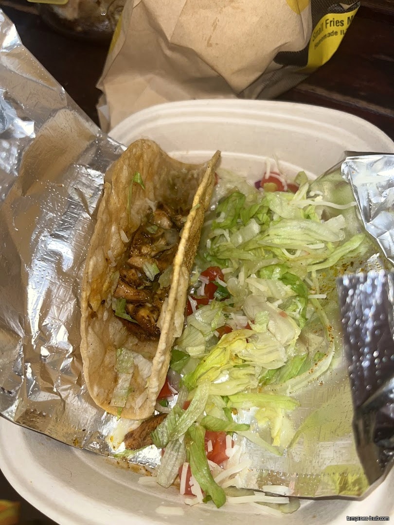 A taco with lettuce and other toppings in a container.
