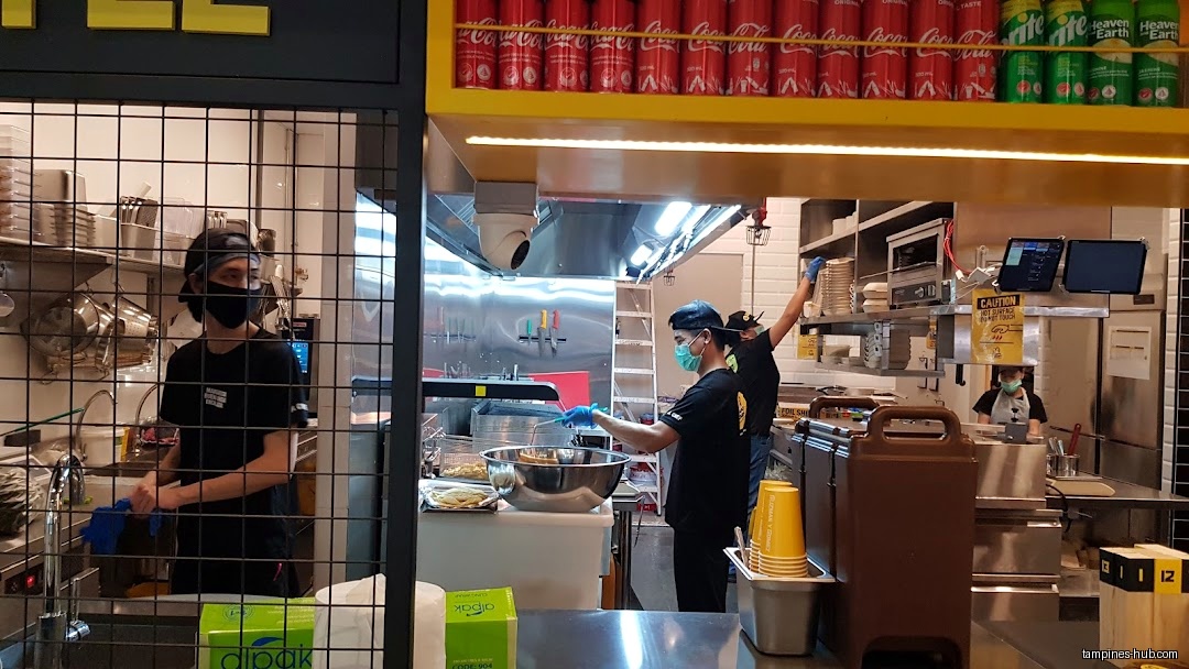 Guzman y Gomez kitchen with staff preparing food and drinks.