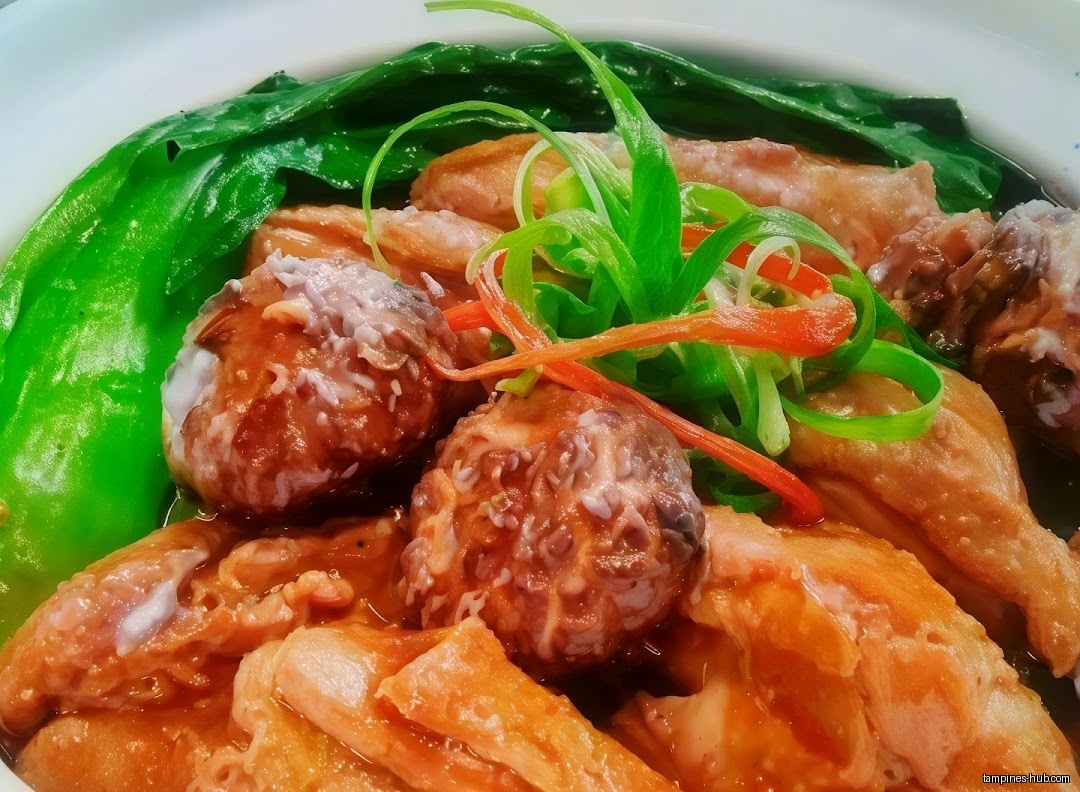 Close-up of a dish with meatballs, tofu, and green vegetables.