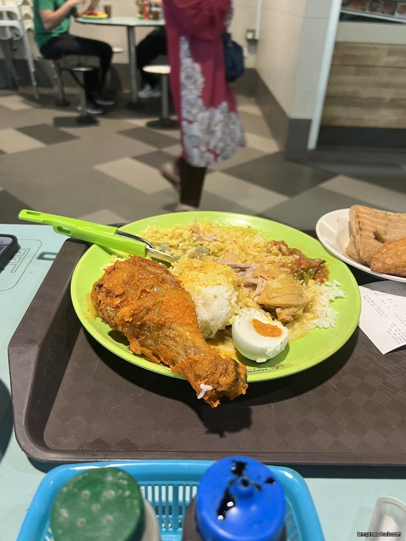 A plate of food with fried chicken, rice, and a boiled egg.