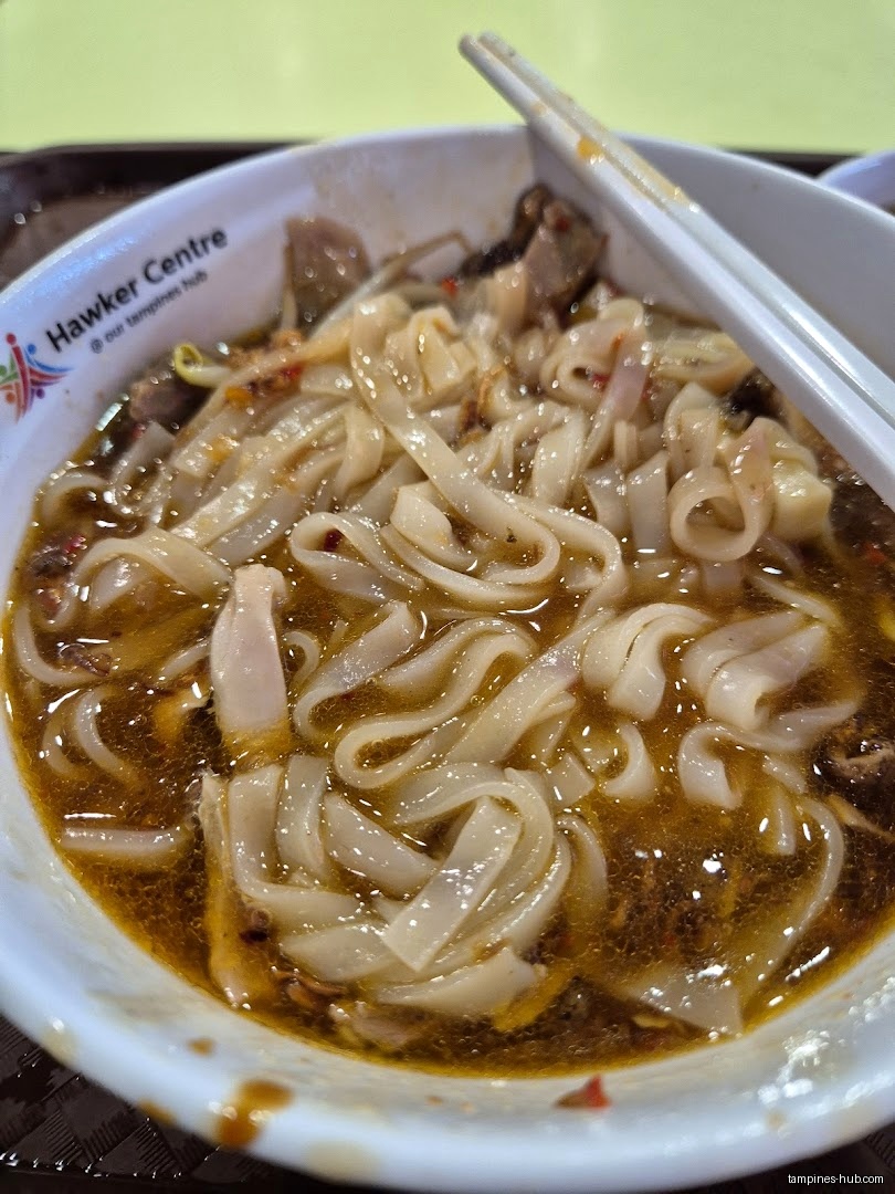A bowl of noodles in broth with chopsticks, from Hawker Centre.