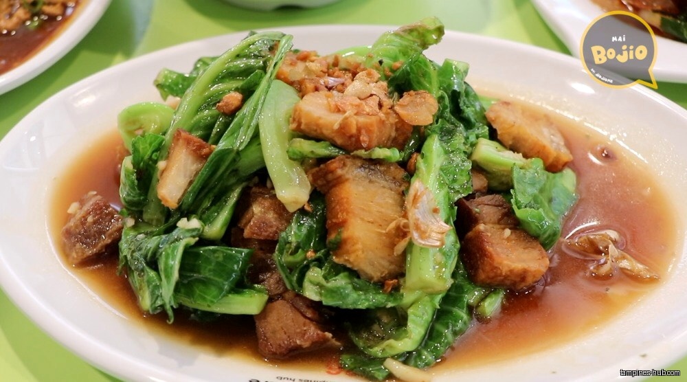 A plate of stir-fried vegetables and pork in a brown sauce.