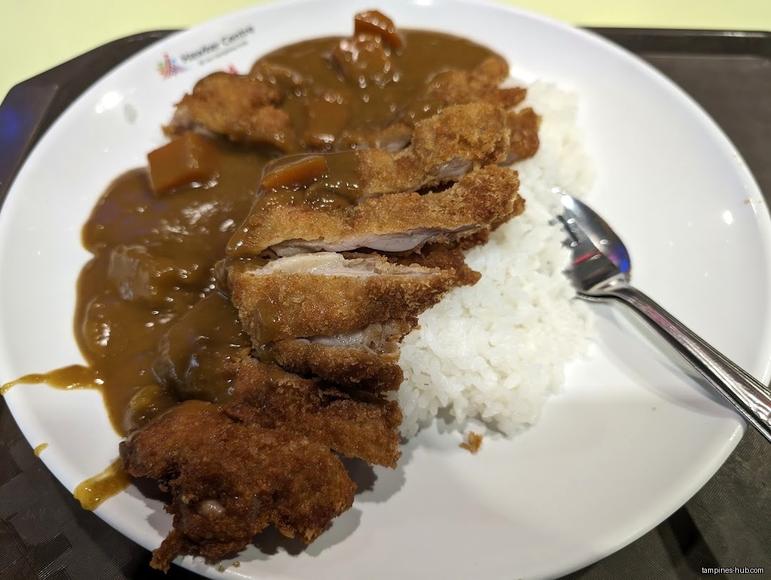 A plate of Japanese curry rice with fried pork cutlet (tonkatsu).