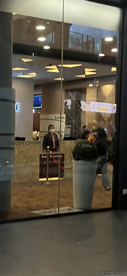 The image shows the glass entrance of HDB Tampines Branch.