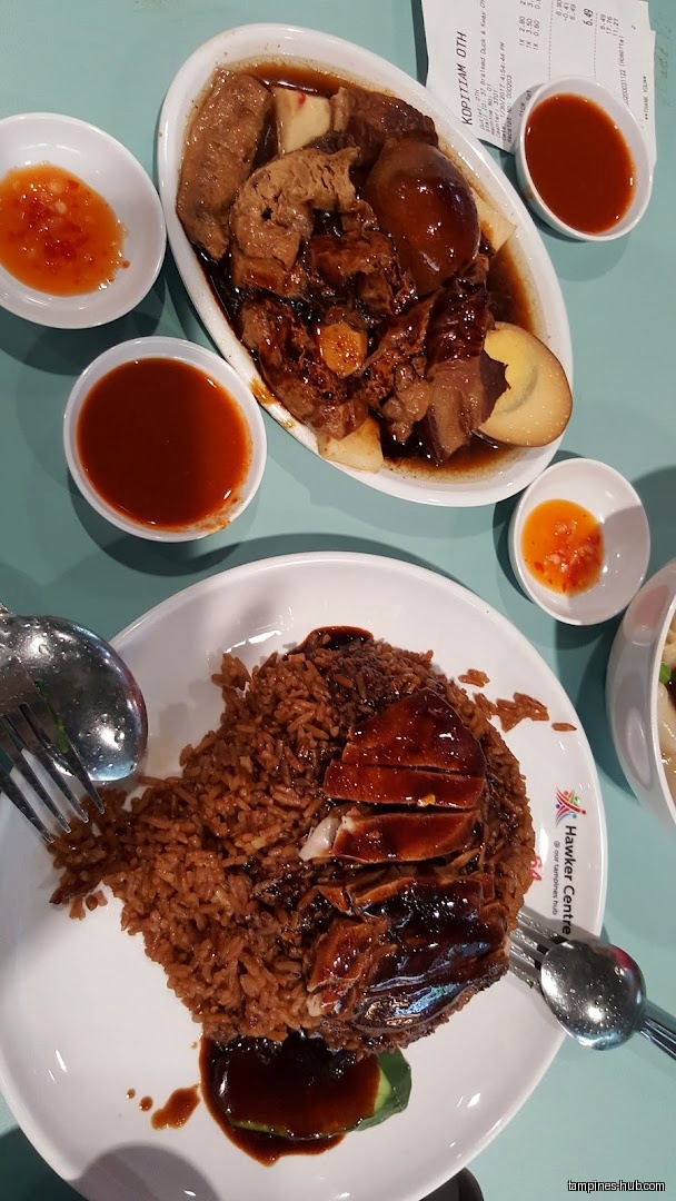 Overhead shot of braised duck rice and braised duck with sides.