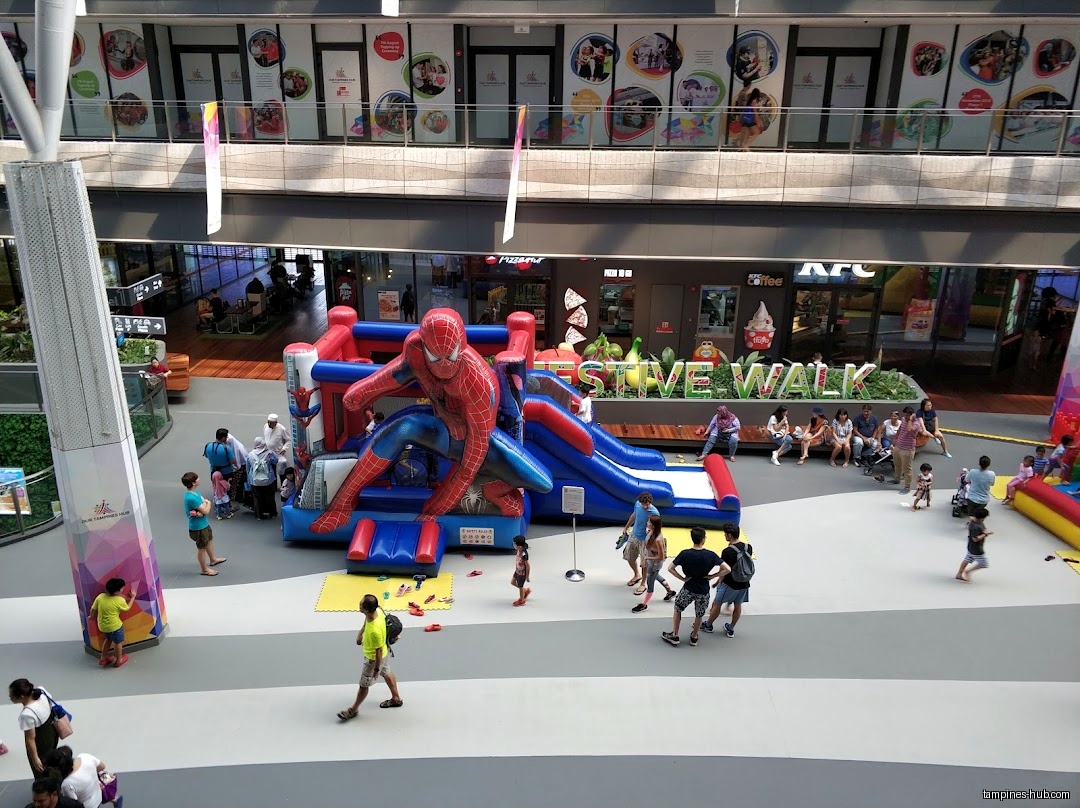 A Spiderman bouncy castle is set up in a shopping mall.