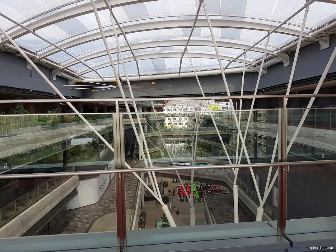 Interior view of Our Tampines Hub with a glass roof and multiple levels.