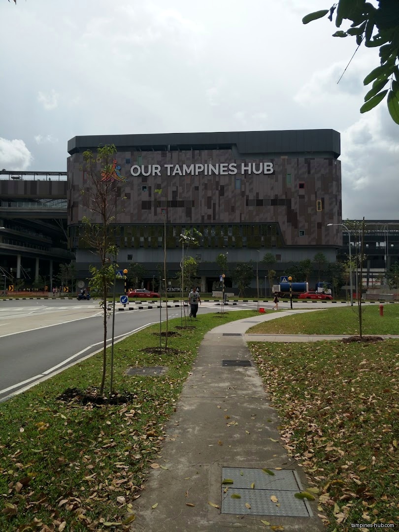 Exterior view of Our Tampines Hub building on a cloudy day.