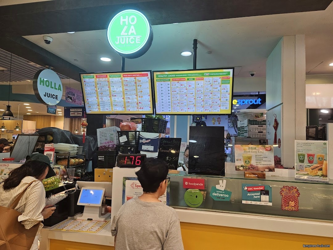 Holla Juice shop interior with customers, menu boards, and point of sale.