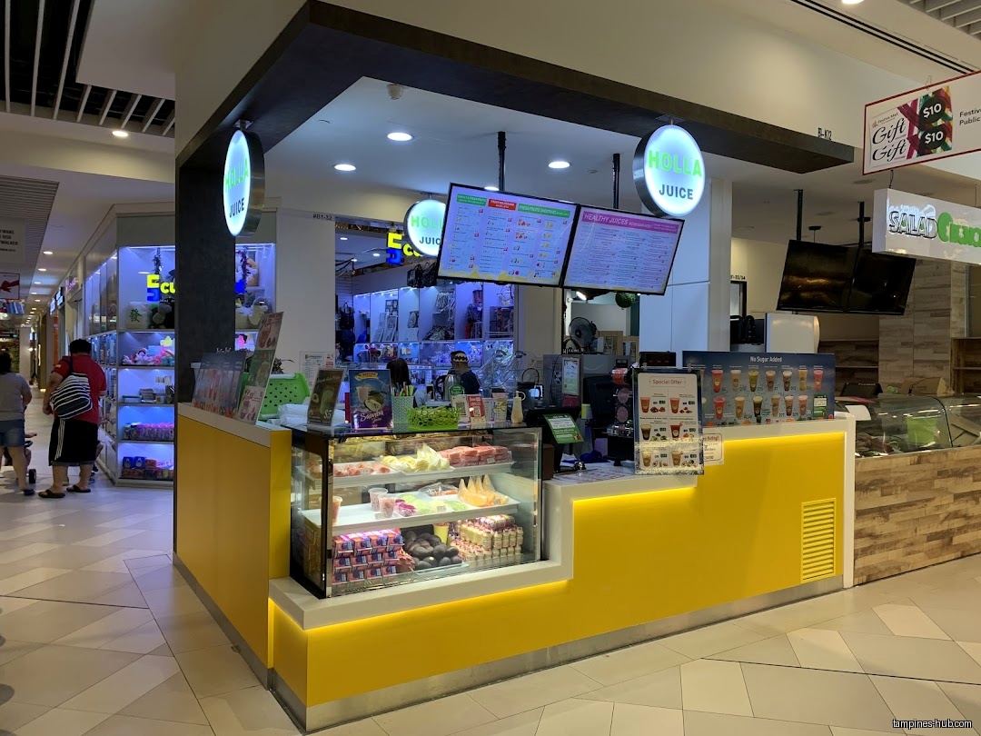 Holla Juice shop front with menu boards and display case in a mall.