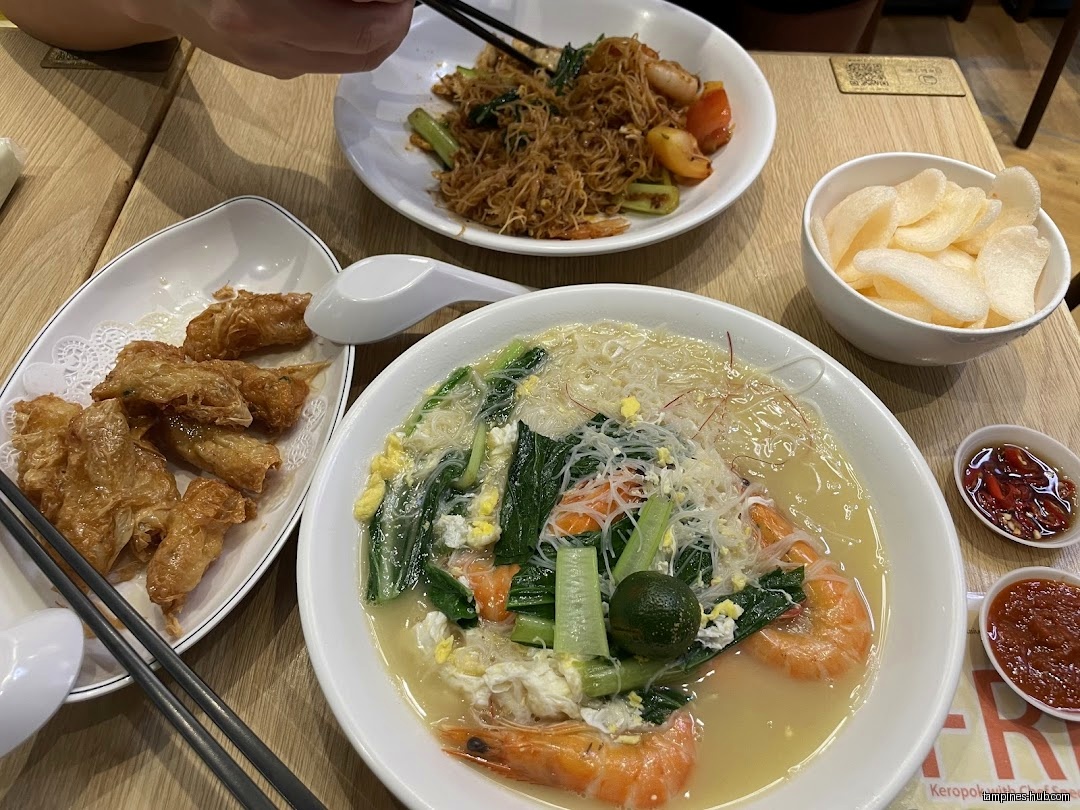 The image shows a table with various dishes, including bee hoon and shrimp.