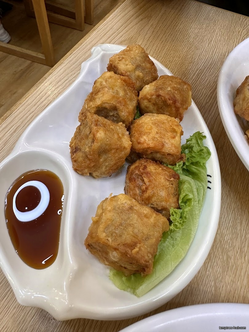 A plate of fried food with sauce, likely served at the restaurant.