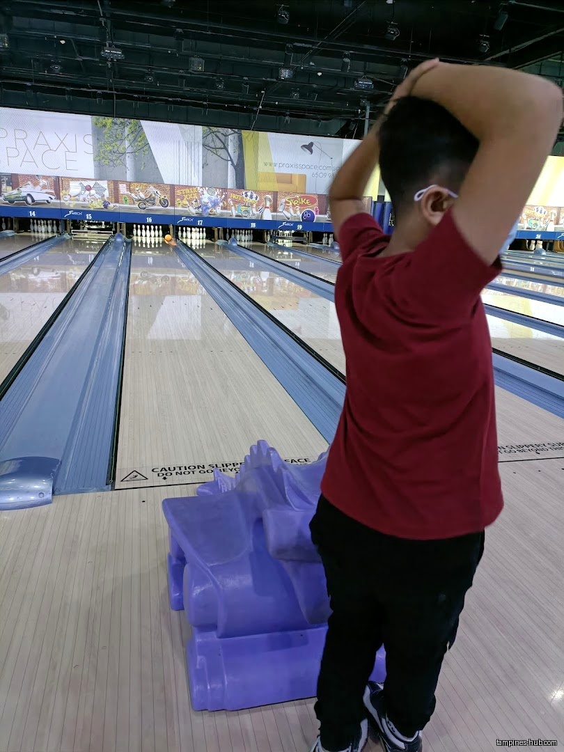 A person is bowling in a bowling alley with bowling lanes.