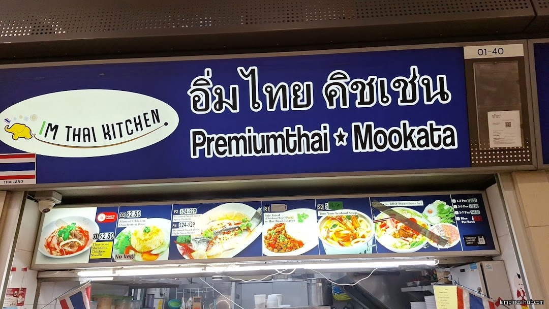 IM Thai Kitchen shop front with menu board and Thai flags.