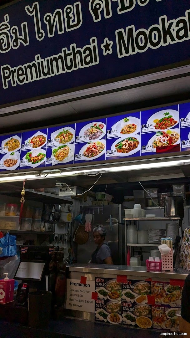 IM Thai Kitchen stall with menu board and staff at hawker centre.
