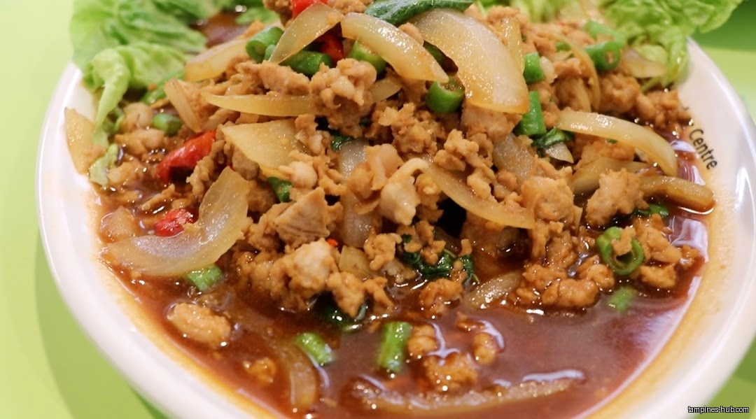A close-up shot of a Thai dish with minced meat and onions.