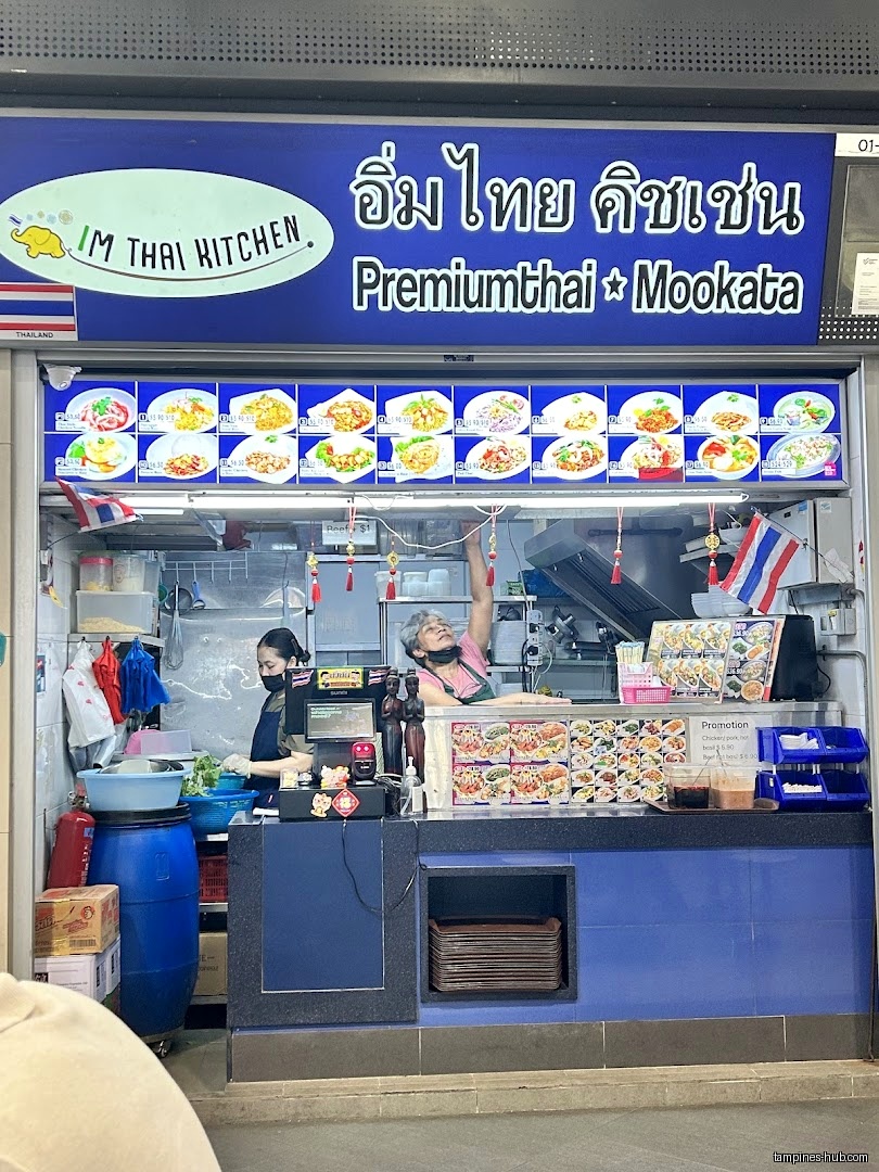 IM Thai Kitchen shop front with menu board and staff visible.