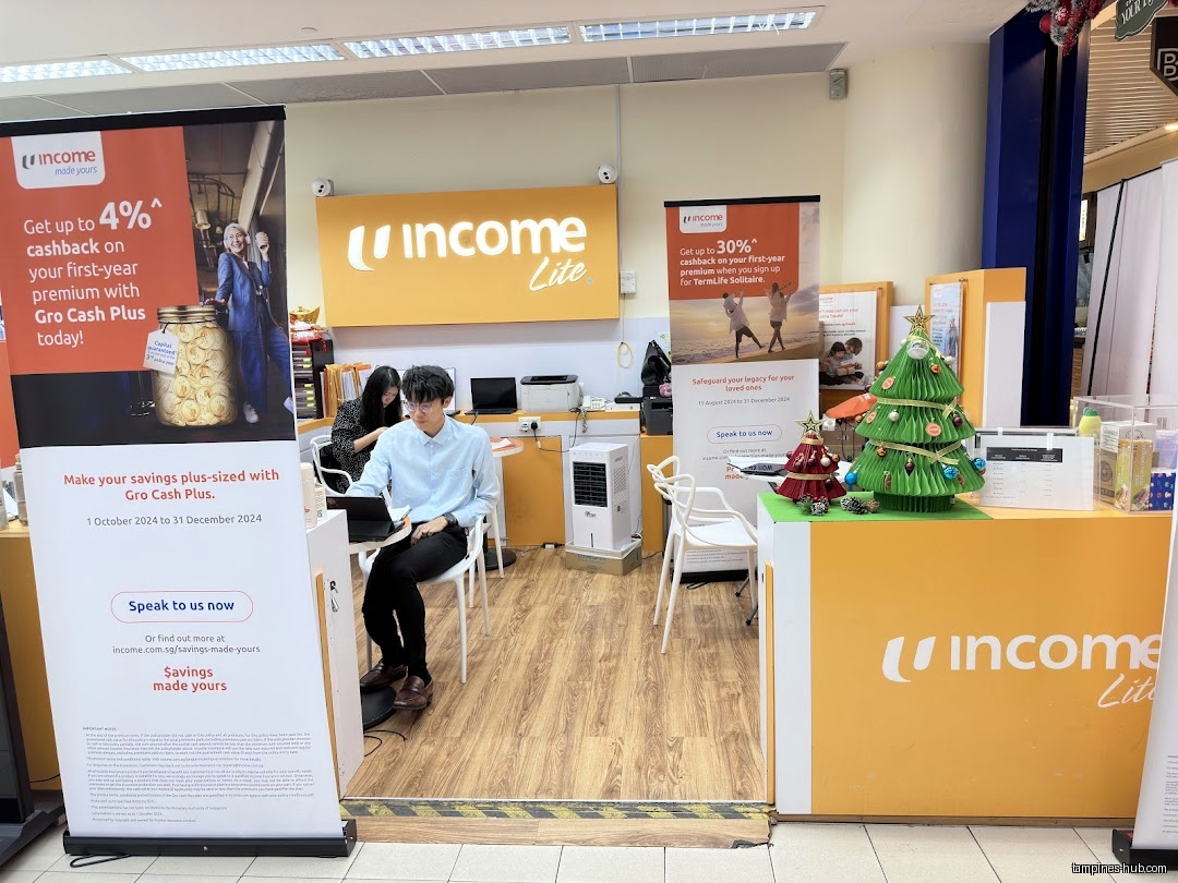 The Income Insurance Tampines Hub Lite Branch shop front with staff inside.