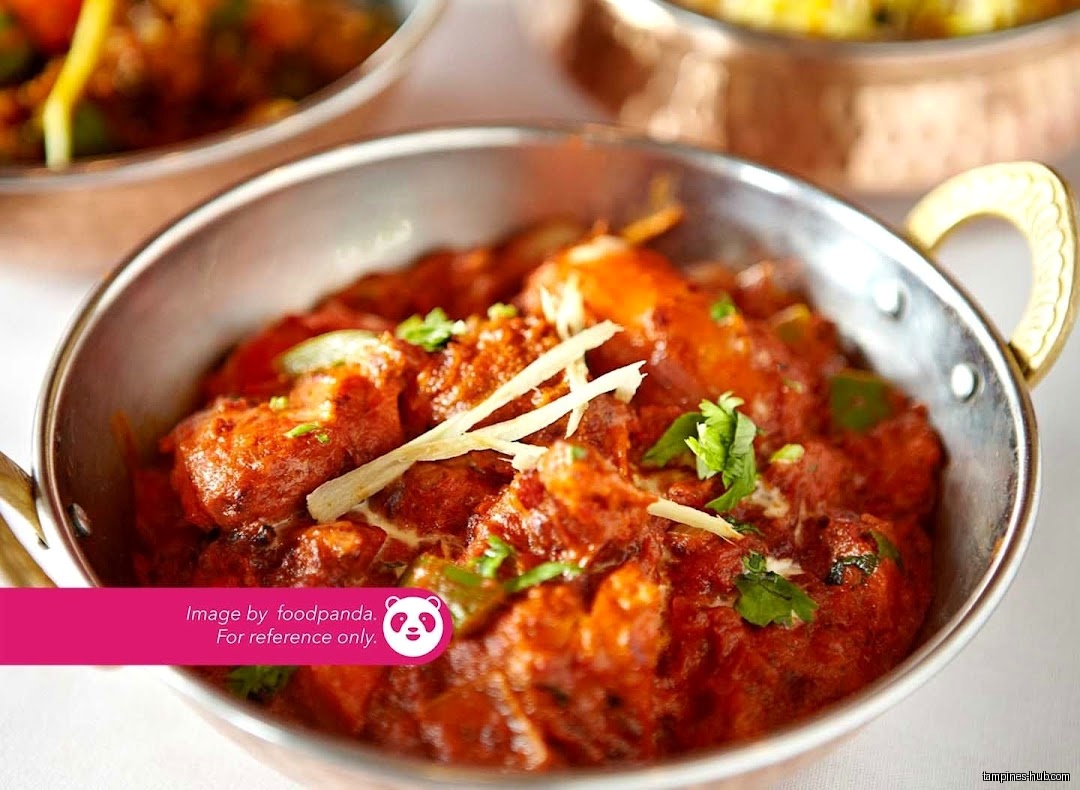 A bowl of Indian Cuisine, specifically chicken tikka masala, is shown.