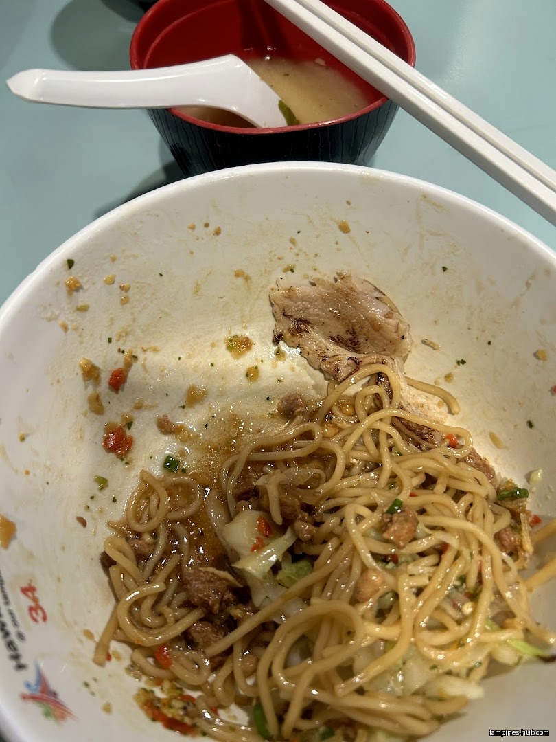 Close-up of a nearly empty bowl of noodles and a bowl of soup.