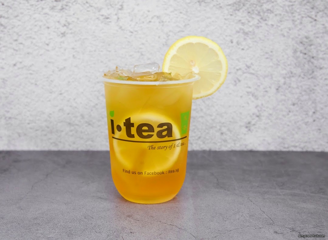 A cup of iTEA drink with ice and a lemon slice.