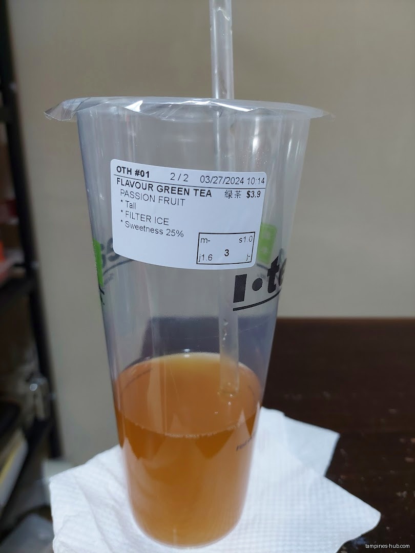 A cup of iTEA's passion fruit green tea with a straw is shown.
