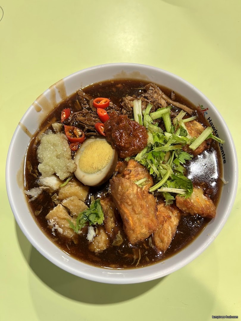A bowl of Lor Mee with various toppings is shown.