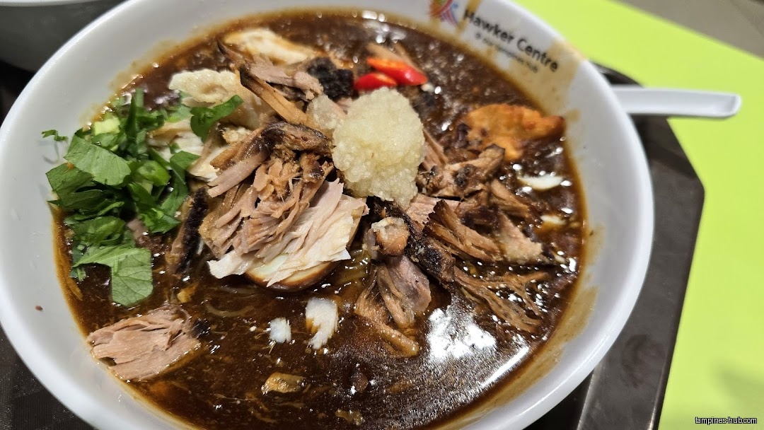 A bowl of Lor Mee with meat, herbs, and a thick gravy.