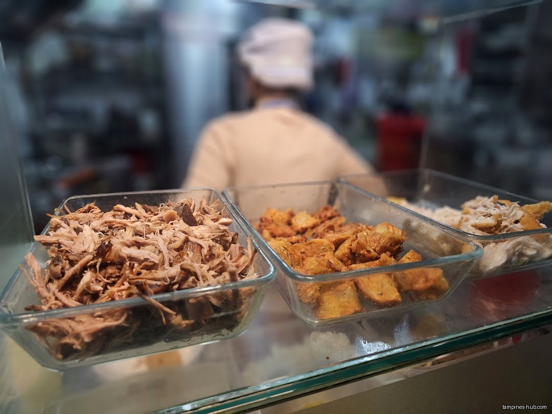 Three glass containers hold shredded meat, fried tofu, and other toppings.
