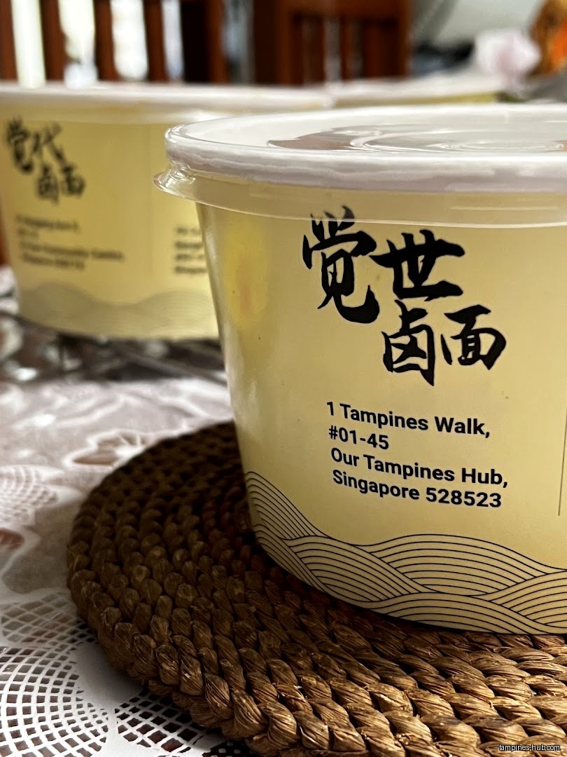 Two containers of Jue Shi Lor Mee are on a table.