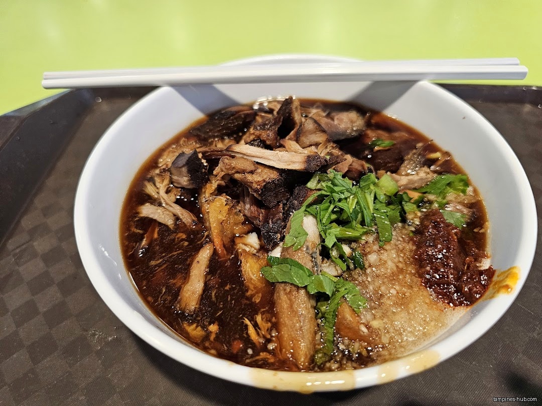 A bowl of Lor Mee with toppings and chopsticks on a tray.